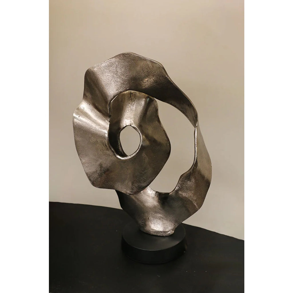 Scalloped sculpture on matt black stand